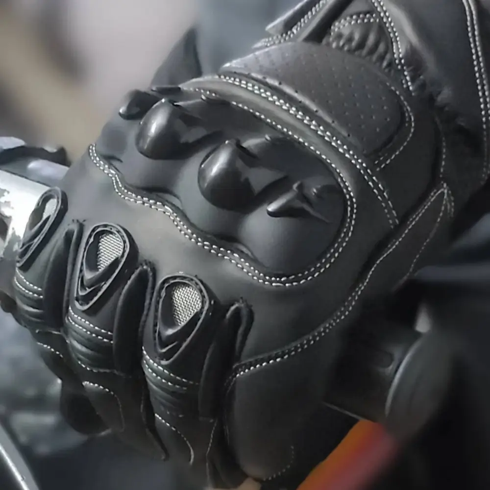 Hard-shell knuckle armor detail on leather motorcycle gloves